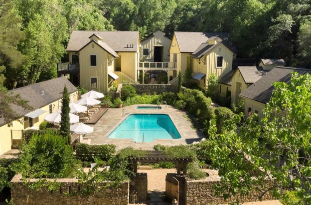 Hotel buildings around a central swimming pool At Farmhouse Inn in California